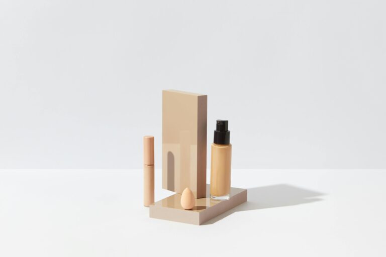 Warm, Cool, Neutral: The Ultimate Guide to Matching Foundation Elegant display of foundation, concealer, and sponge for a clean beauty setup on a white surface.