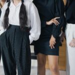 Diverse group of young adults in modern corporate attire indoors.