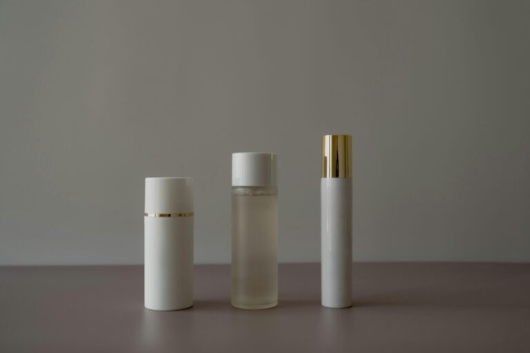 Smooth Affair Mattifying Primer: The Modern Matte Makeup Guide Simple minimalist arrangement of cosmetic bottles on a gray background.