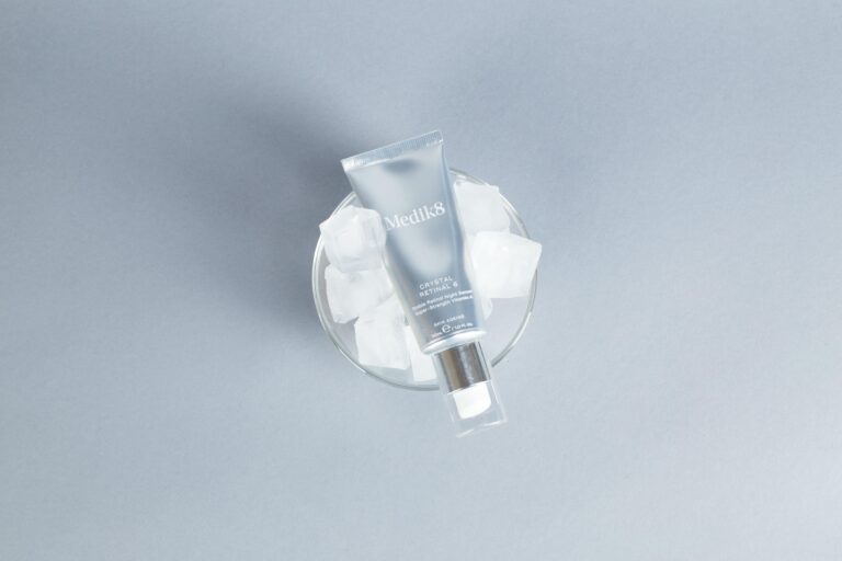 Hyaluronic Acid: Why Everyone Is Talking About It Minimalist flatlay of skincare product on ice with gray background.