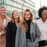 women+wearing+blazers+standing+outside+office+building